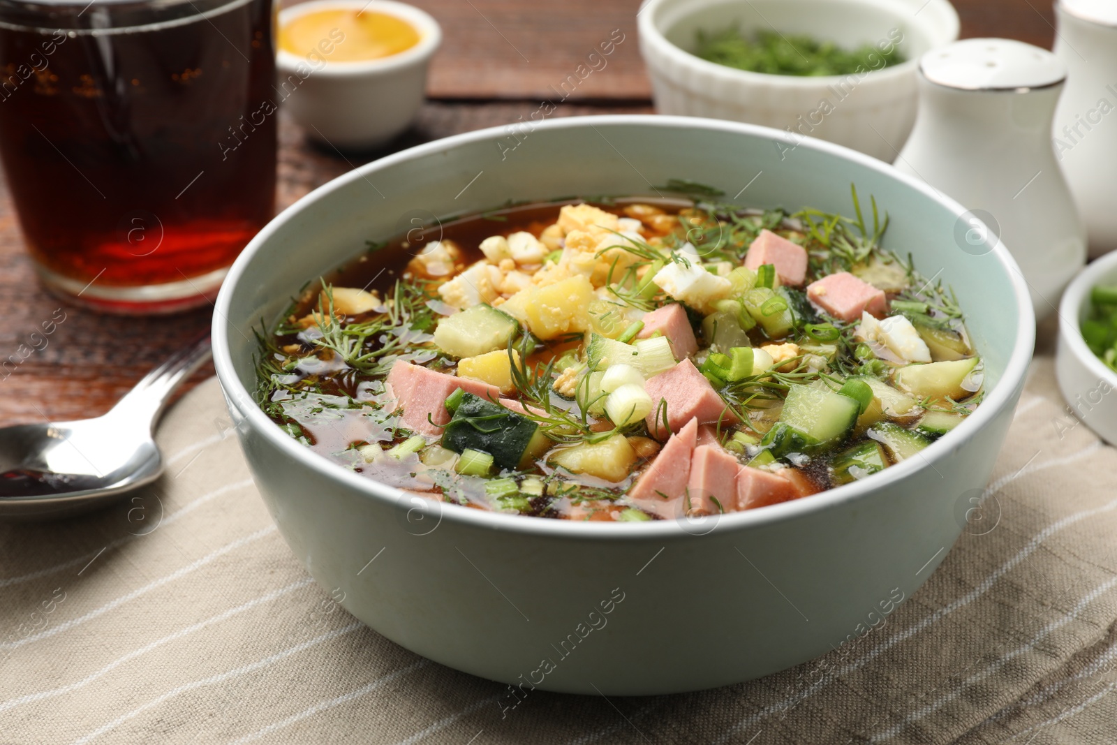 Photo of Delicious okroshka soup with kvass served on table, closeup