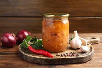 Photo of Canned meat in glass jar and fresh products on wooden table