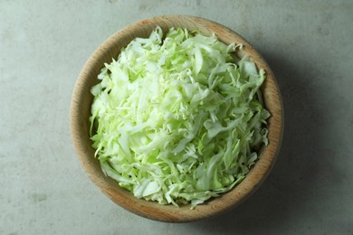 Photo of Fresh shredded cabbage on light table, top view