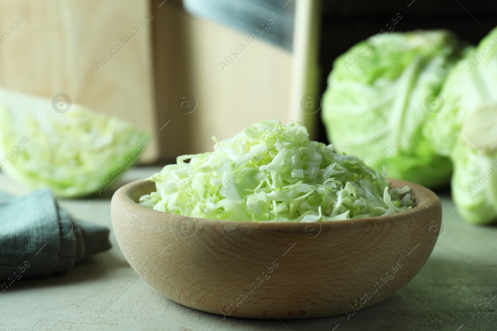 Photo of Fresh shredded cabbage on light table, closeup