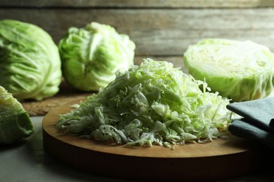 Photo of Fresh shredded cabbage on light table, closeup