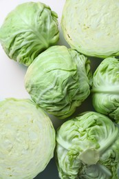 Photo of Raw green cabbages on white background, flat lay