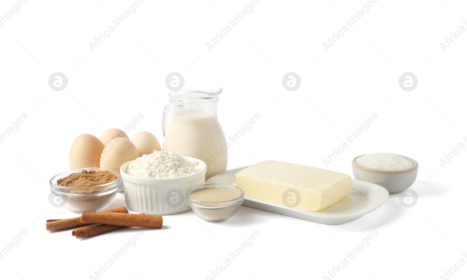 Photo of Making cinnamon rolls. Different ingredients for dough isolated on white