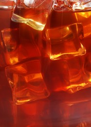 Photo of Refreshing coffee with ice cubes as background, closeup