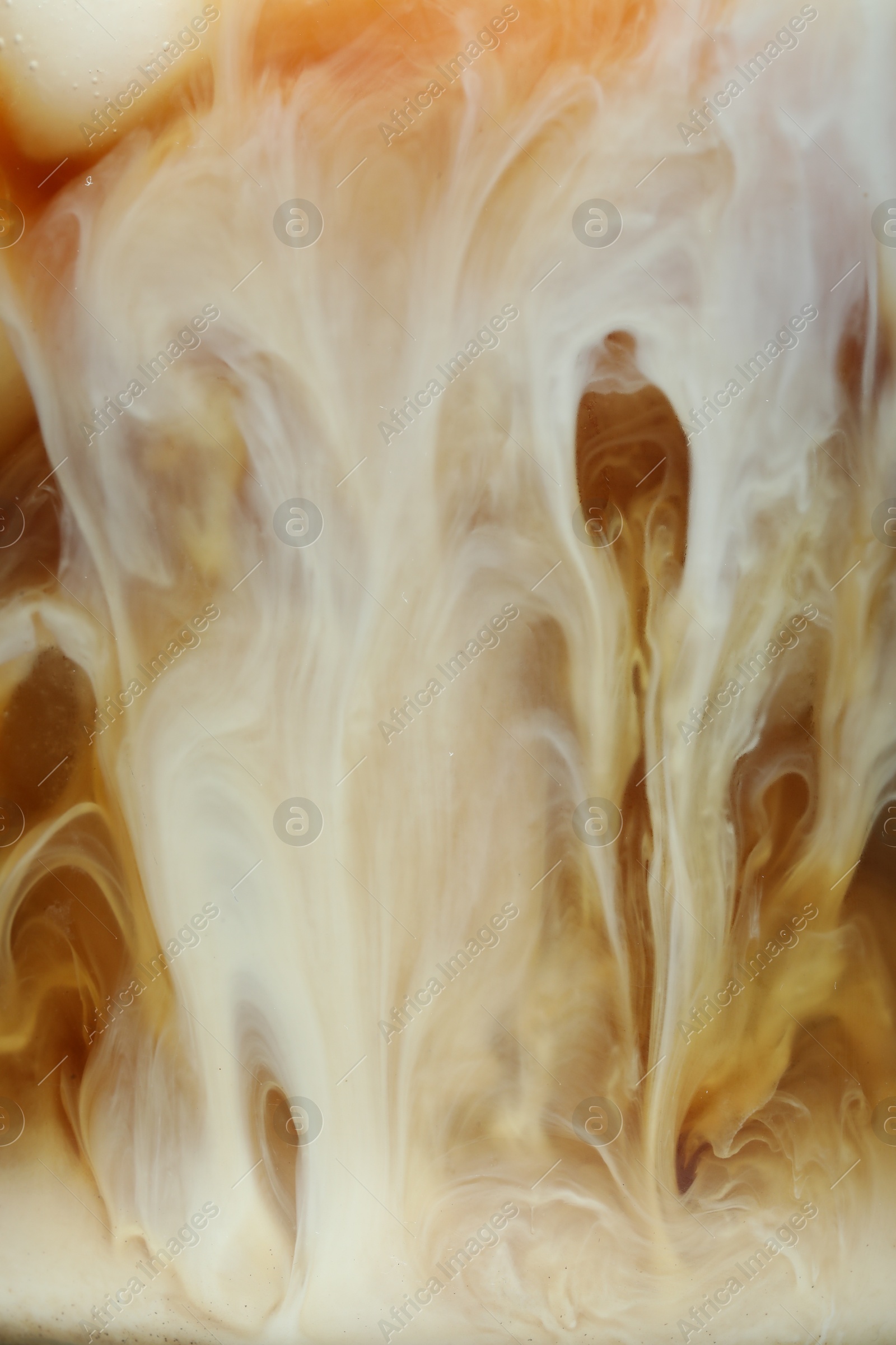 Photo of Refreshing coffee with ice and milk as background, closeup