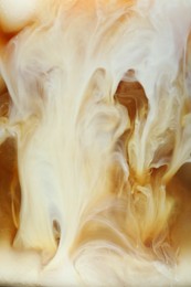 Photo of Refreshing coffee with ice and milk as background, closeup