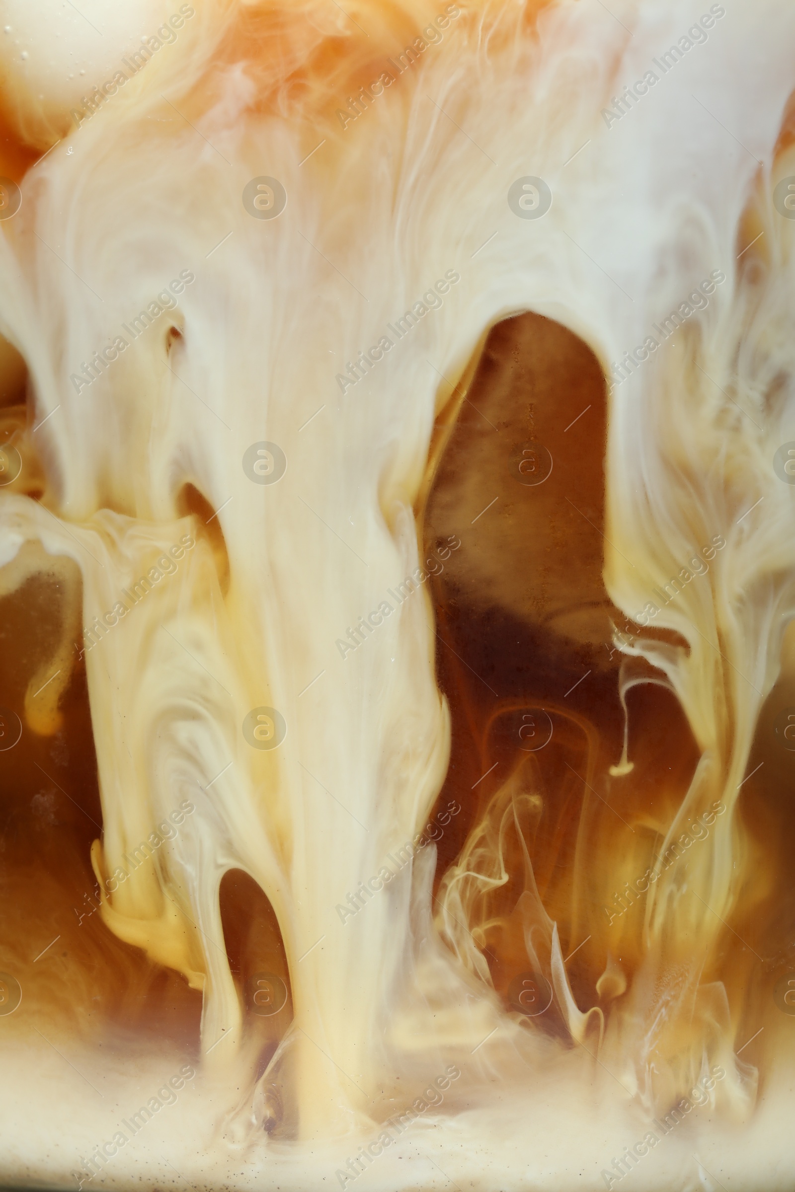 Photo of Refreshing coffee with ice and milk as background, closeup