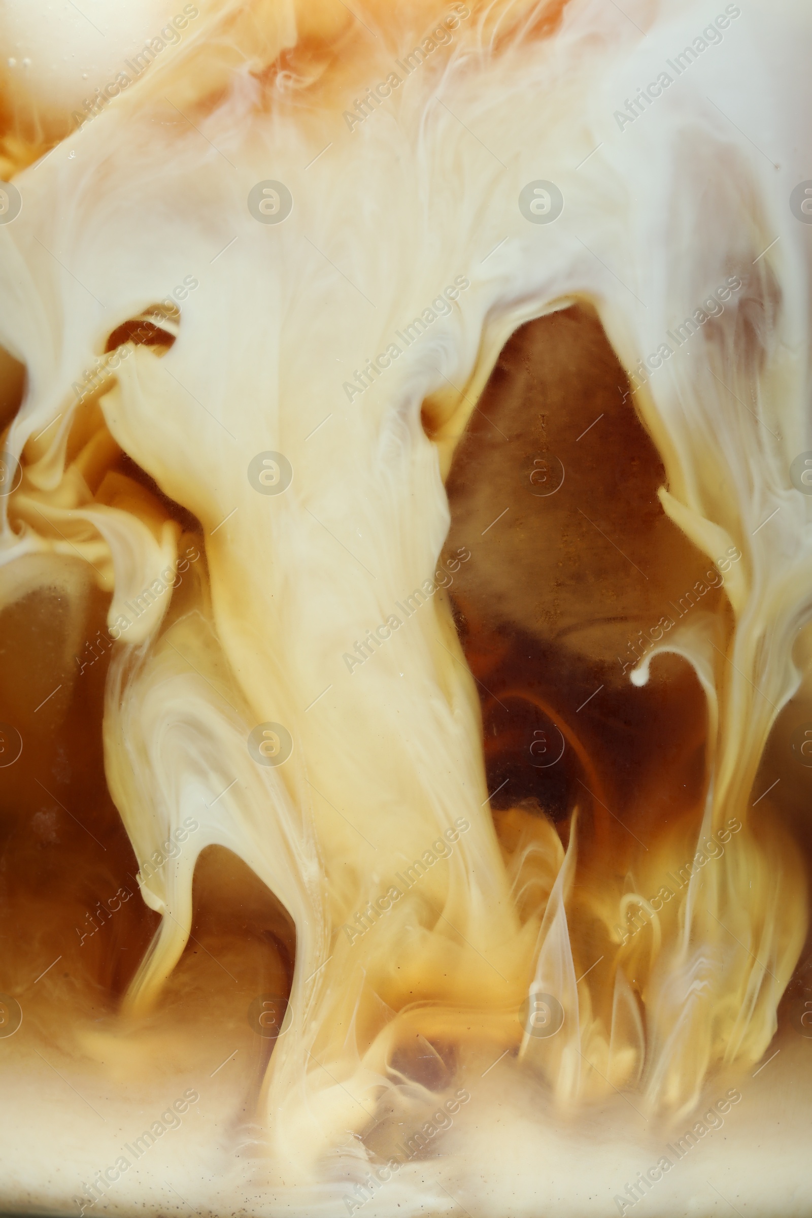 Photo of Refreshing coffee with ice and milk as background, closeup