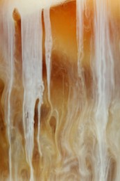 Photo of Refreshing coffee with ice and milk as background, closeup