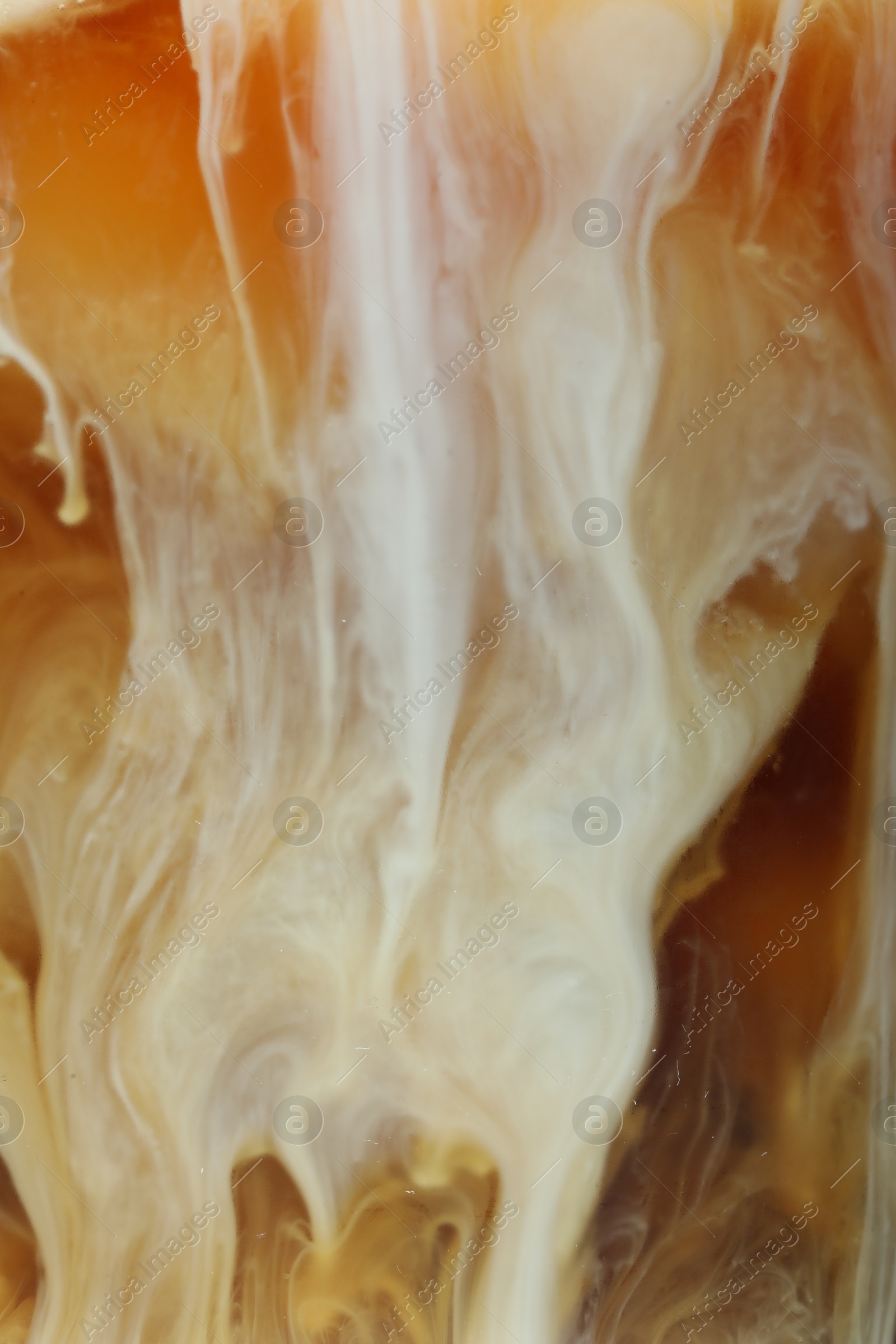 Photo of Refreshing coffee with ice and milk as background, closeup