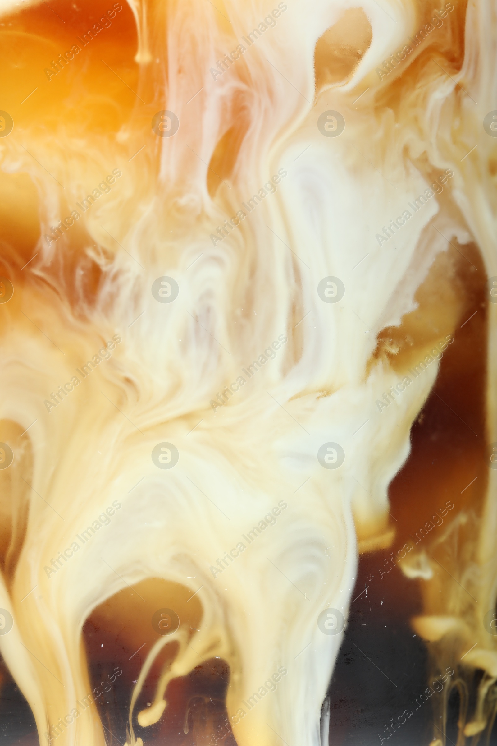 Photo of Refreshing coffee with ice and milk as background, closeup