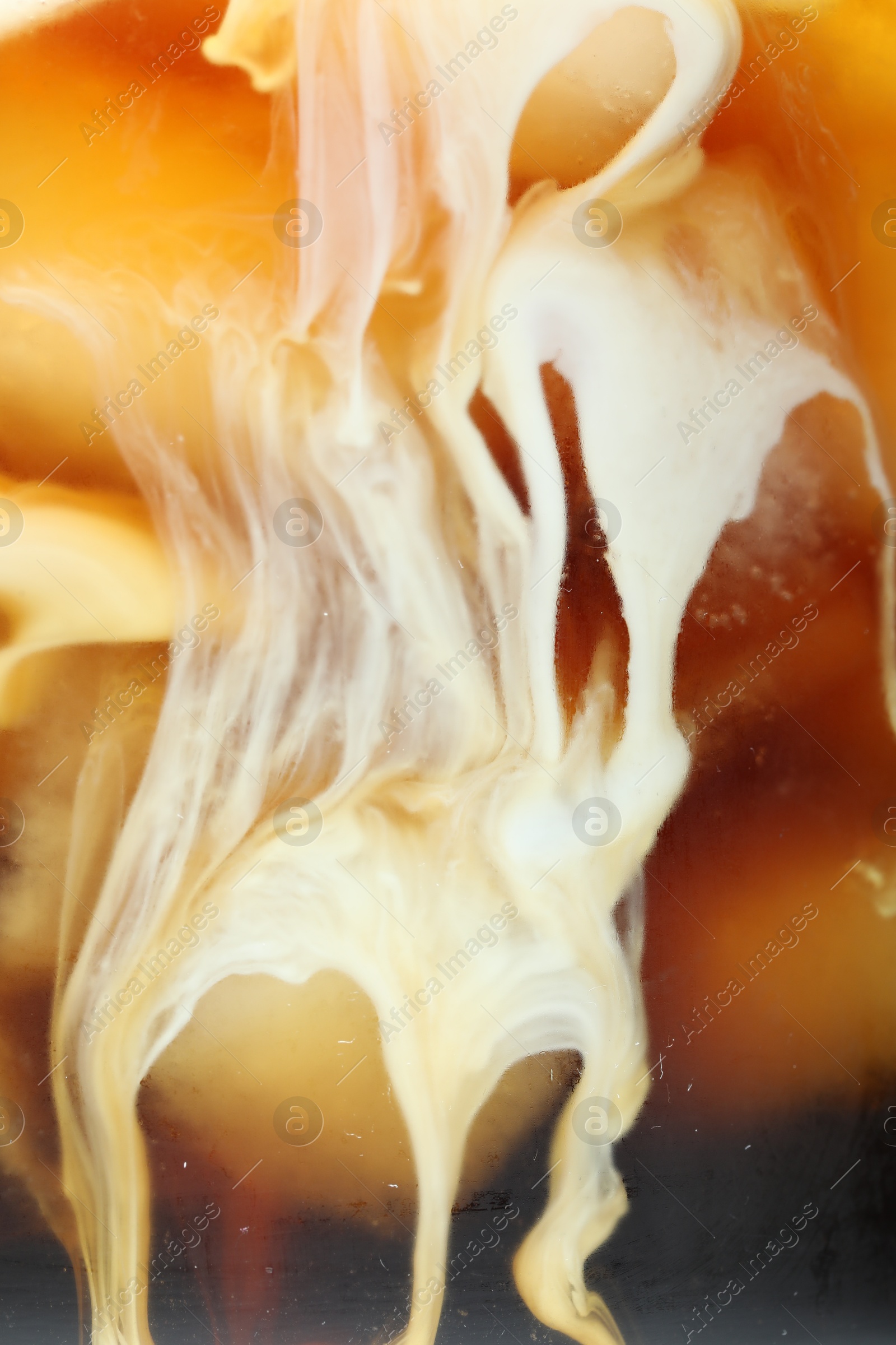 Photo of Refreshing coffee with ice and milk as background, closeup