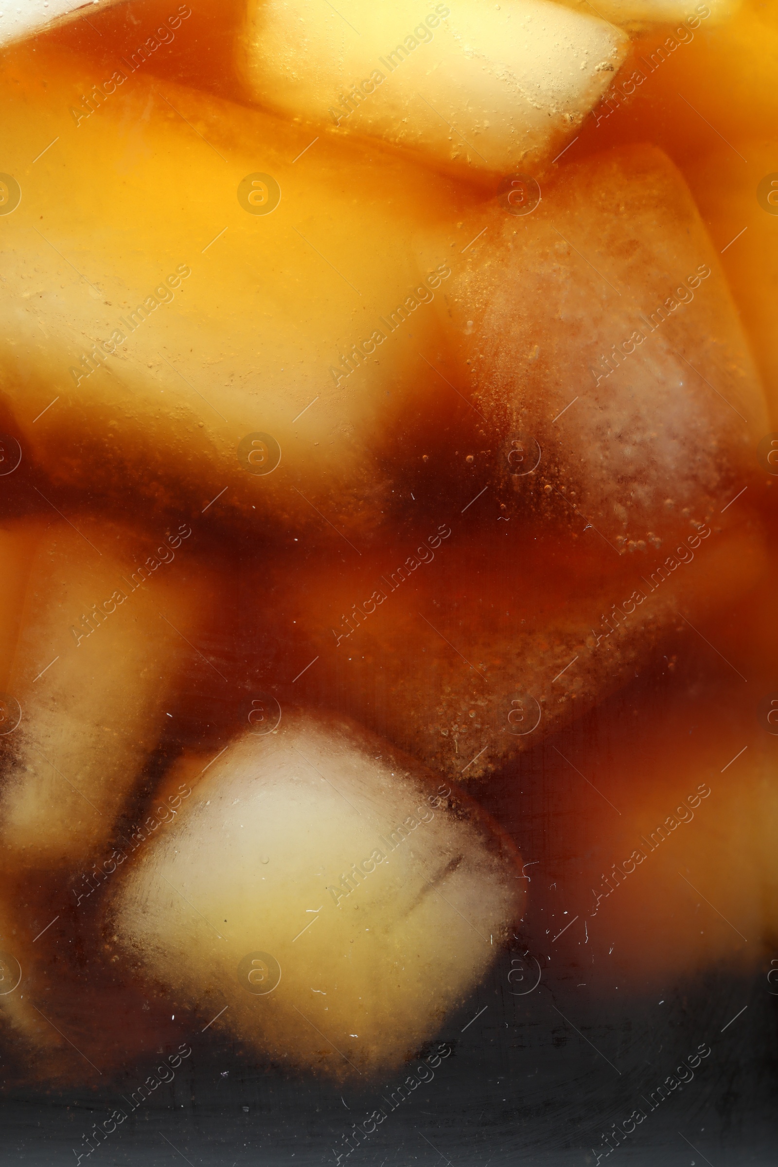 Photo of Refreshing coffee with ice cubes as background, closeup