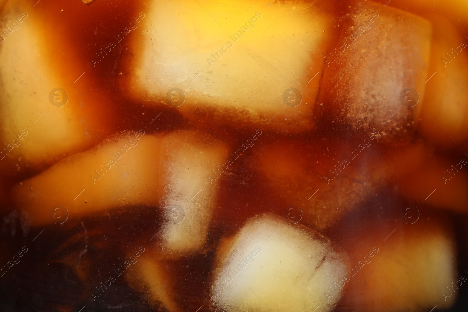 Photo of Refreshing coffee with ice cubes as background, closeup