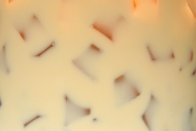 Photo of Refreshing coffee with ice and milk as background, closeup