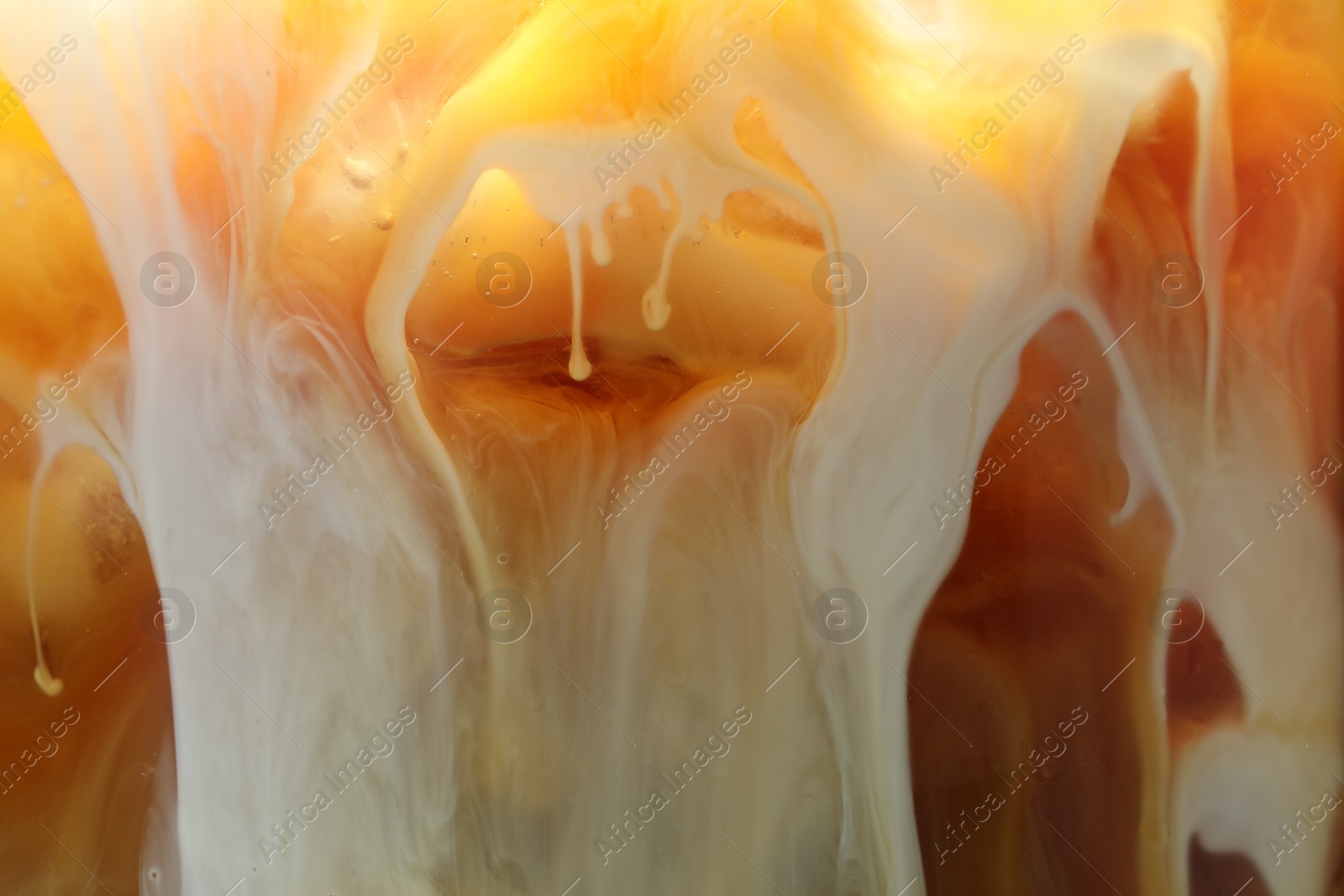 Photo of Refreshing coffee with ice and milk as background, closeup