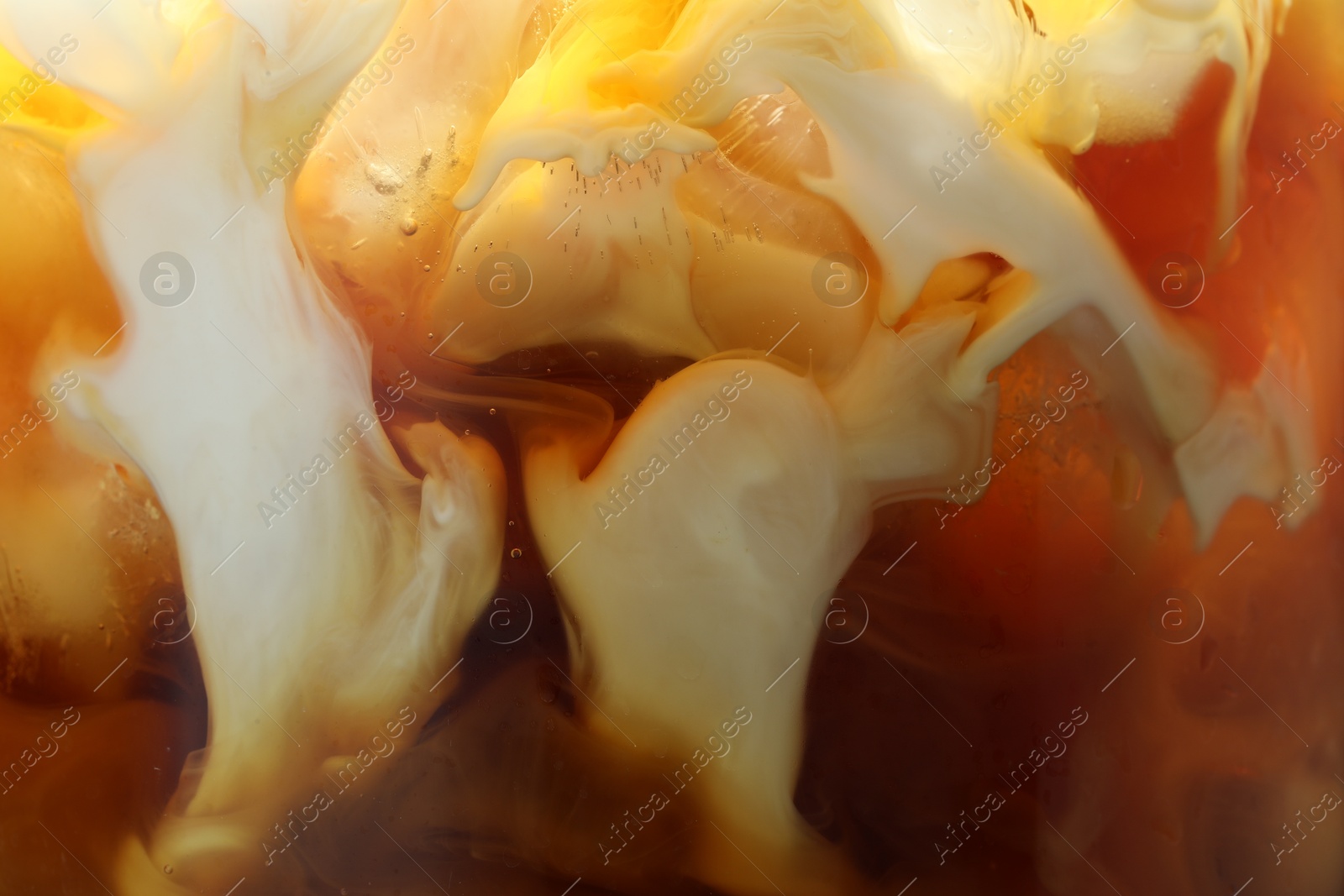 Photo of Refreshing coffee with ice and milk as background, closeup