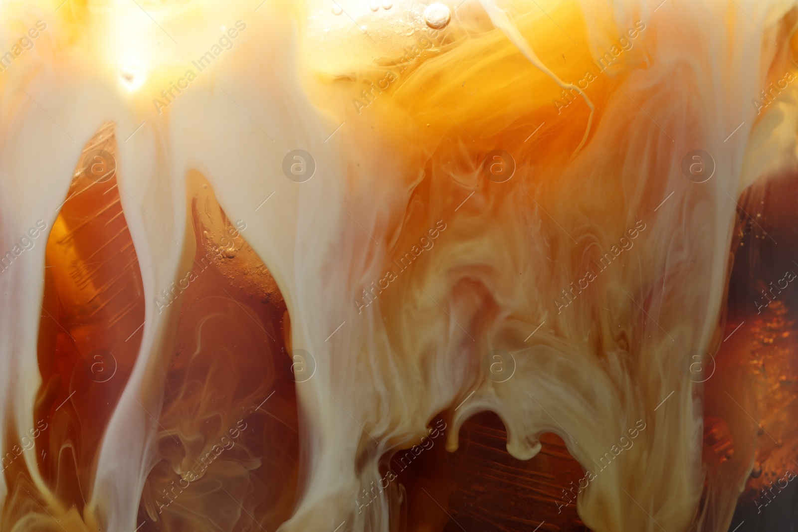 Photo of Refreshing coffee with ice and milk as background, closeup