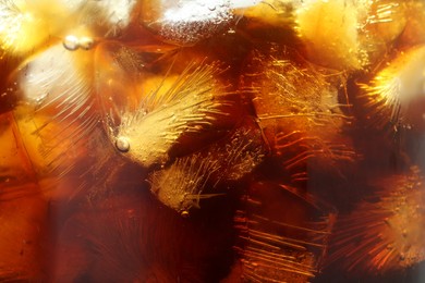 Photo of Refreshing coffee with ice cubes as background, closeup