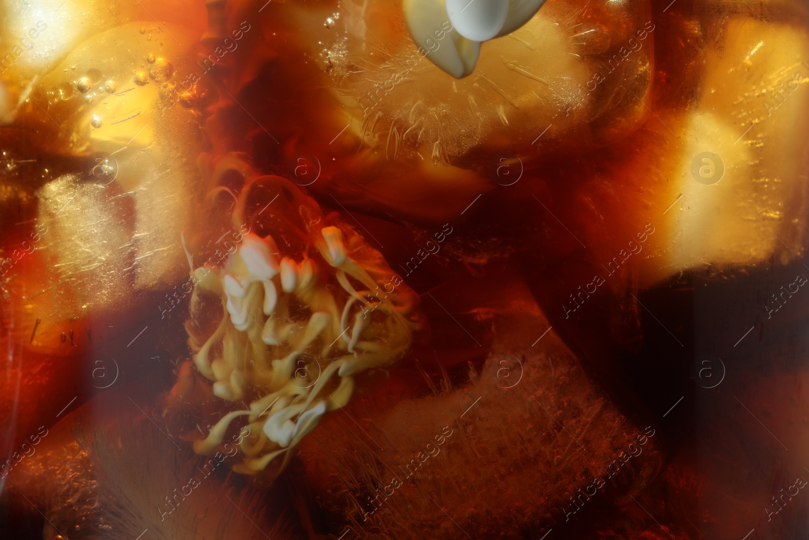 Photo of Refreshing coffee with ice cubes as background, closeup