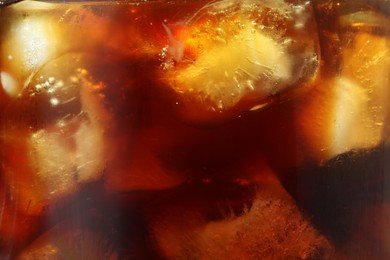 Photo of Refreshing coffee with ice cubes as background, closeup