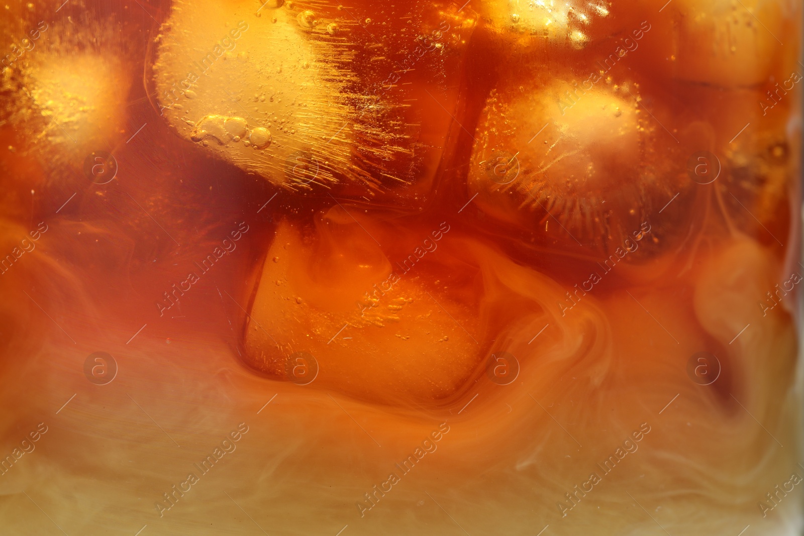 Photo of Refreshing coffee with ice and milk as background, closeup