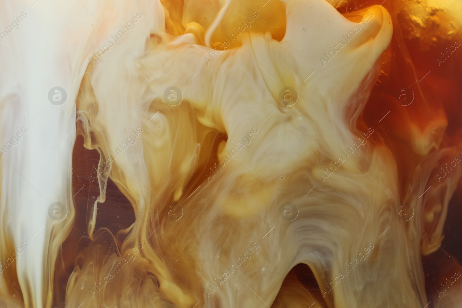 Photo of Refreshing coffee with ice and milk as background, closeup