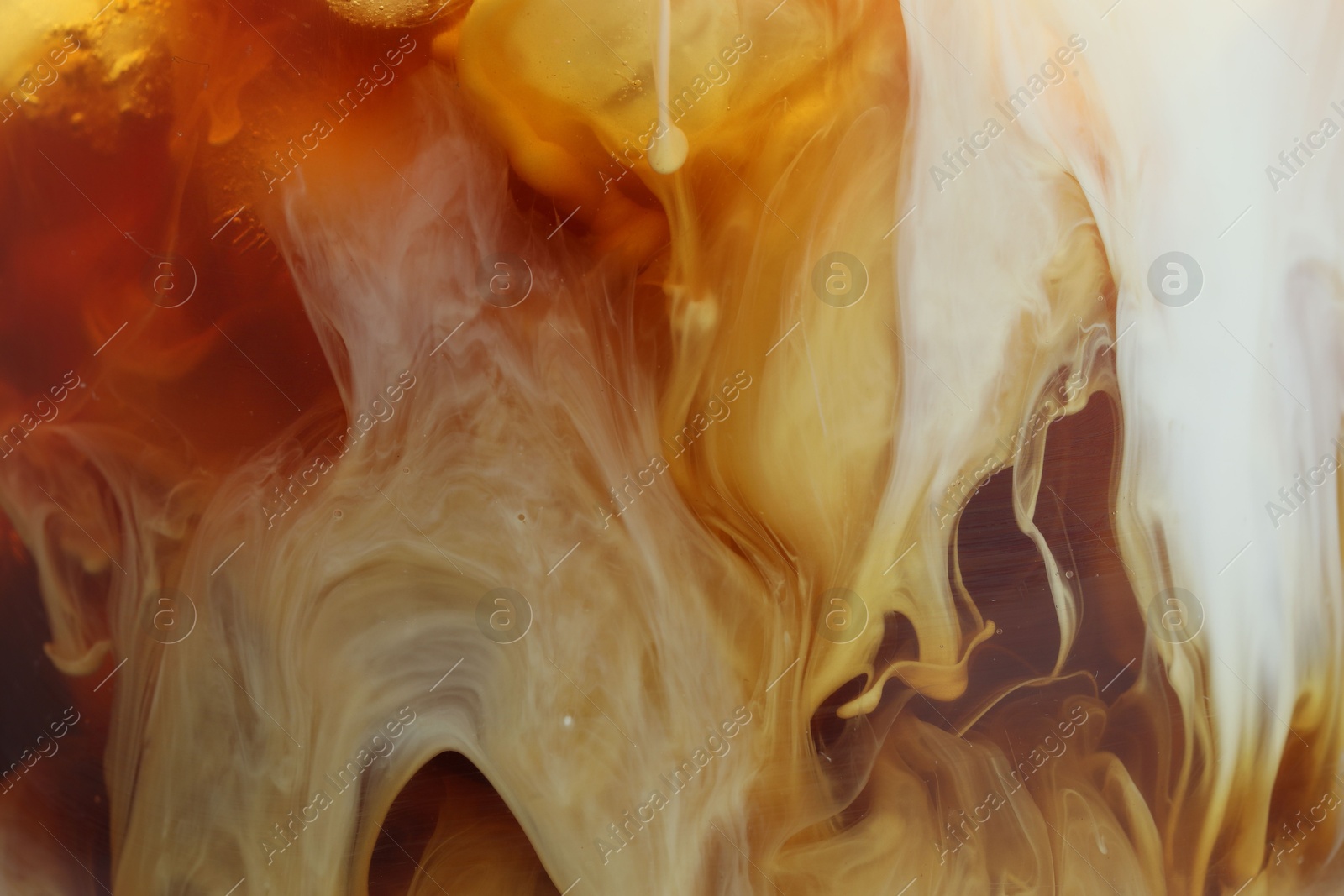 Photo of Refreshing coffee with ice and milk as background, closeup