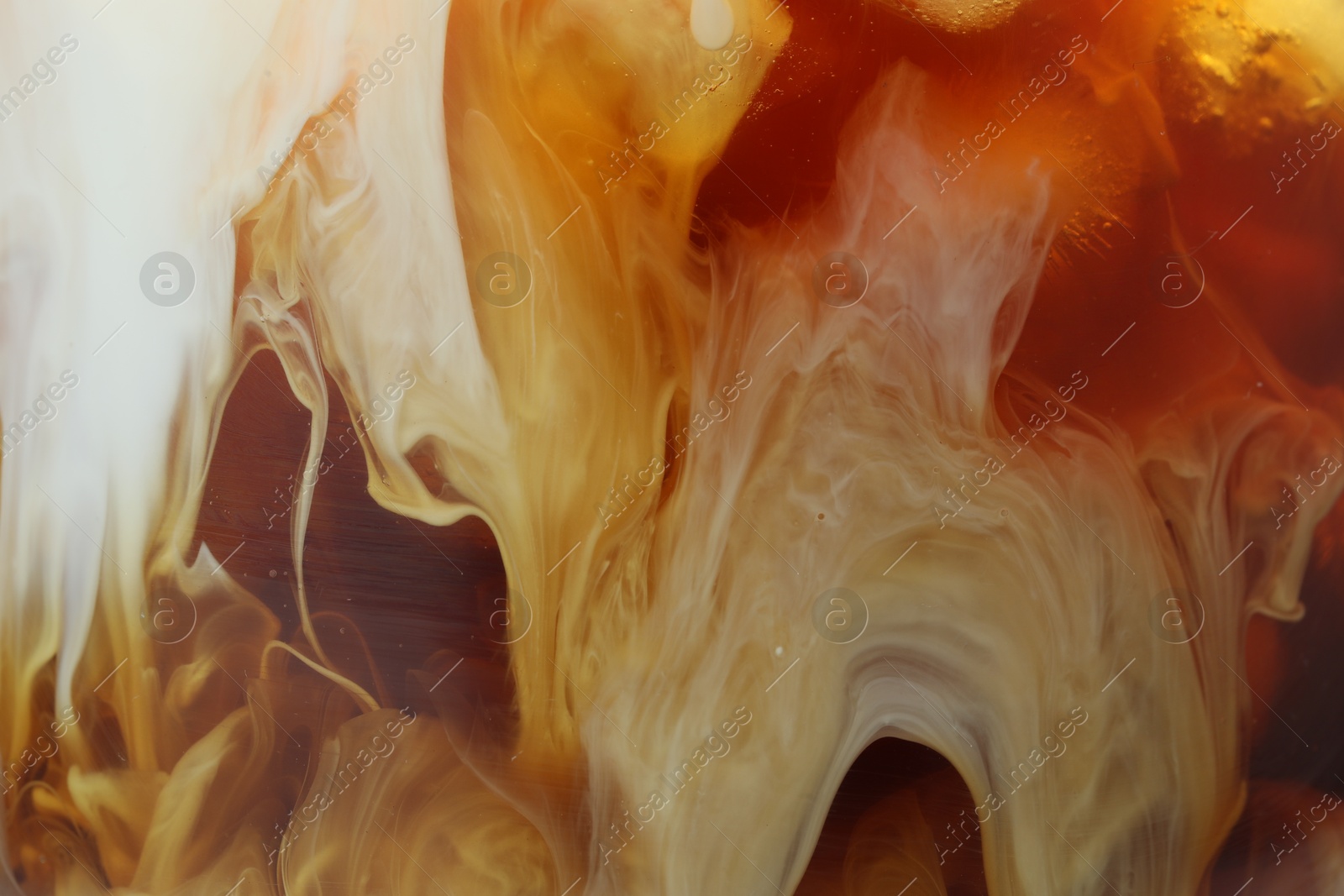 Photo of Refreshing coffee with ice and milk as background, closeup