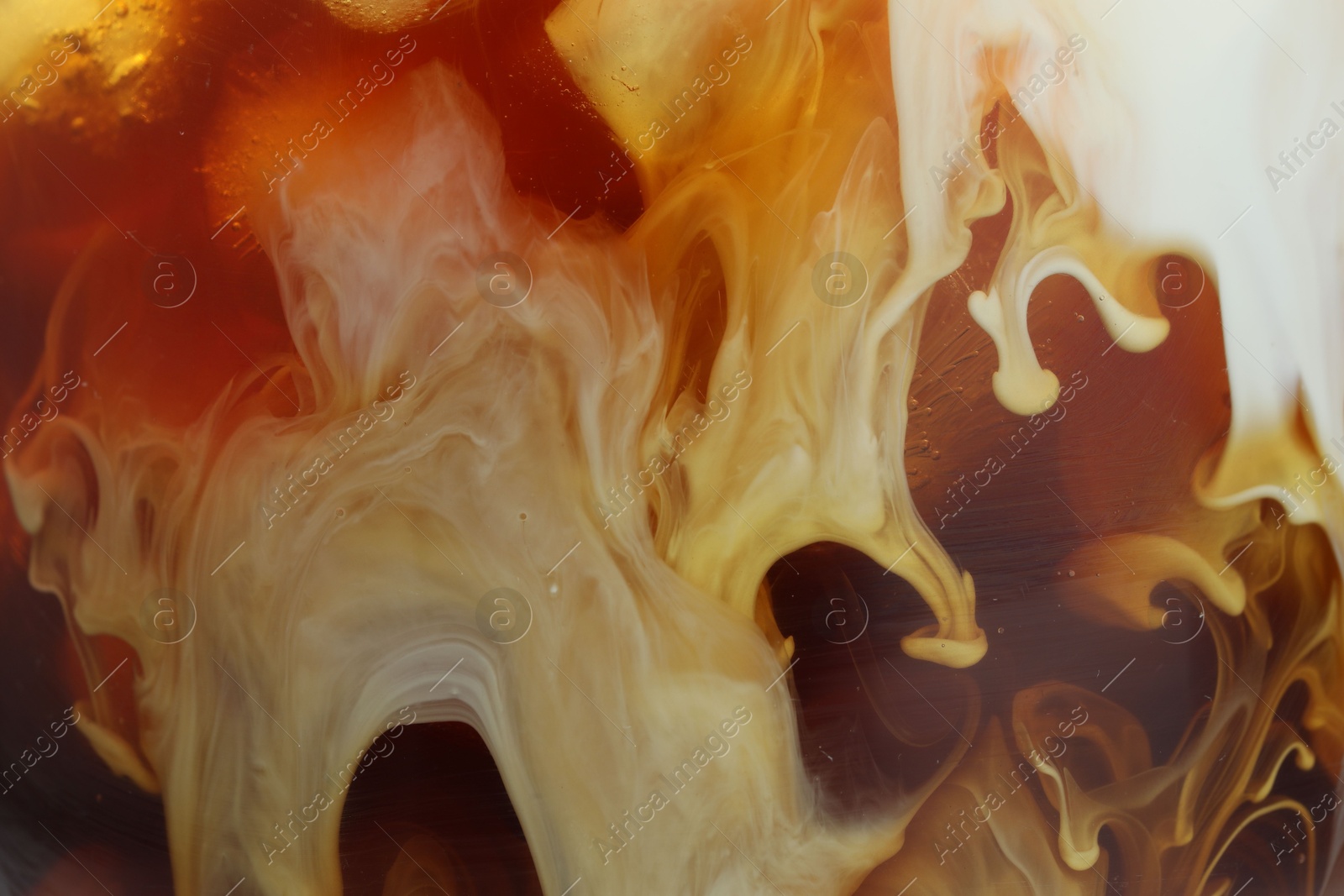 Photo of Refreshing coffee with ice and milk as background, closeup