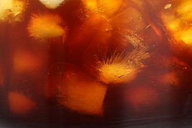 Photo of Refreshing coffee with ice cubes as background, closeup