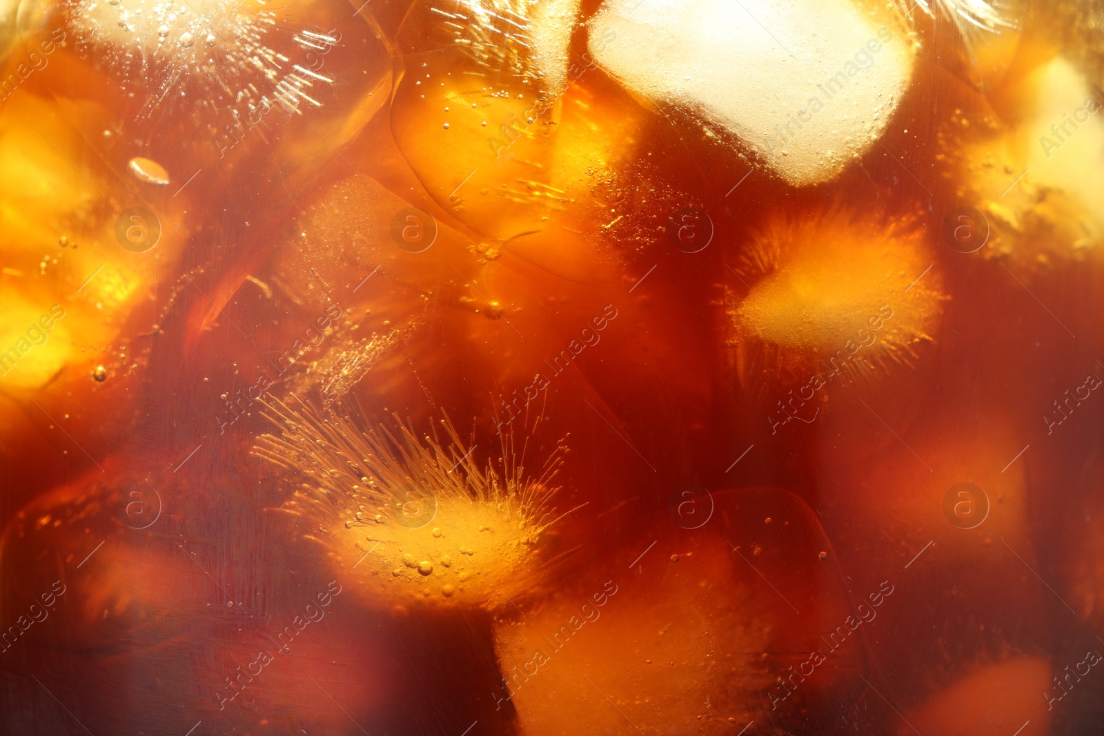 Photo of Refreshing coffee with ice cubes as background, closeup