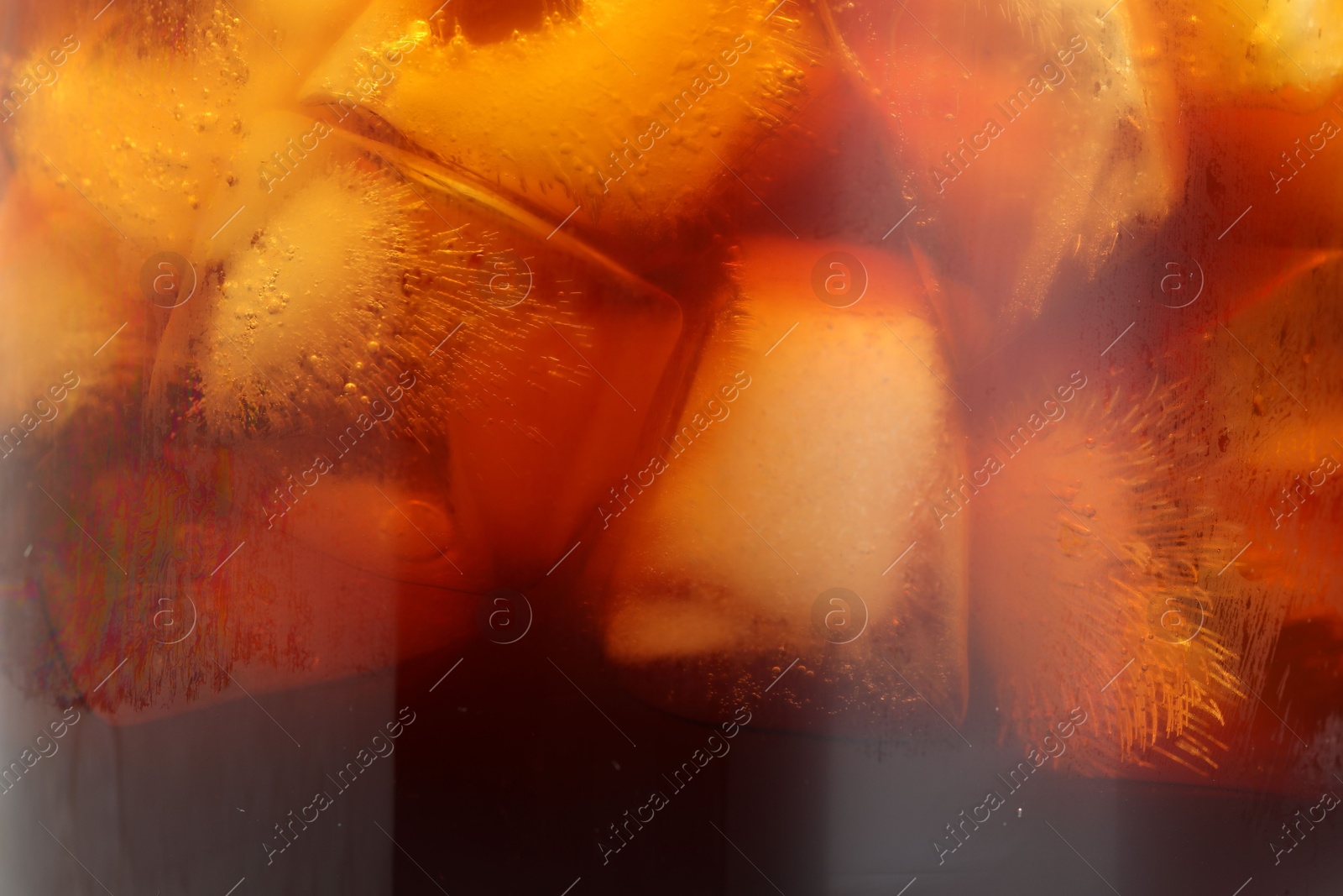 Photo of Refreshing coffee with ice cubes as background, closeup