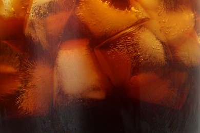 Photo of Refreshing coffee with ice cubes as background, closeup