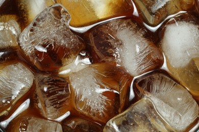 Photo of Refreshing coffee with ice cubes as background, top view