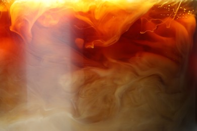 Photo of Refreshing coffee with ice and milk as background, closeup