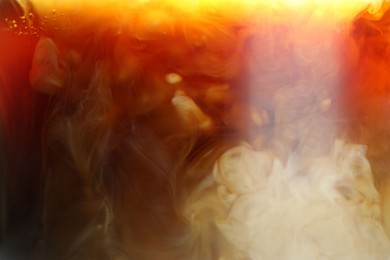 Photo of Refreshing coffee with ice and milk as background, closeup