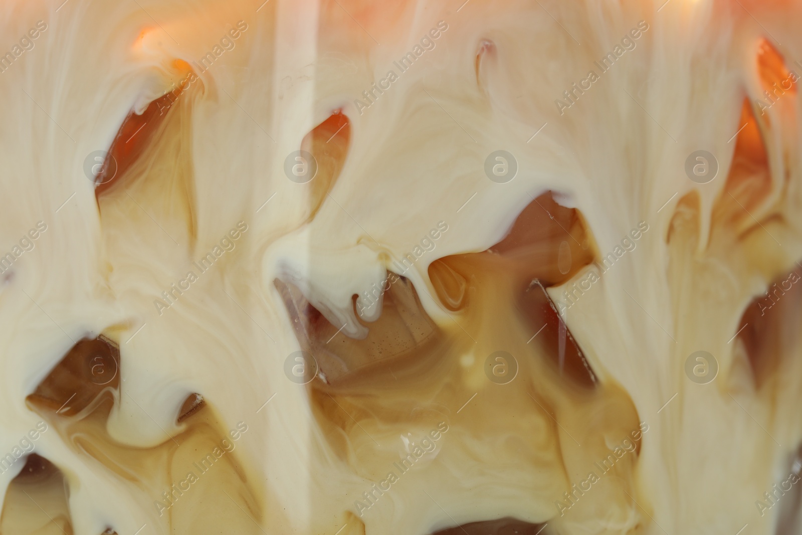 Photo of Refreshing coffee with ice and milk as background, closeup