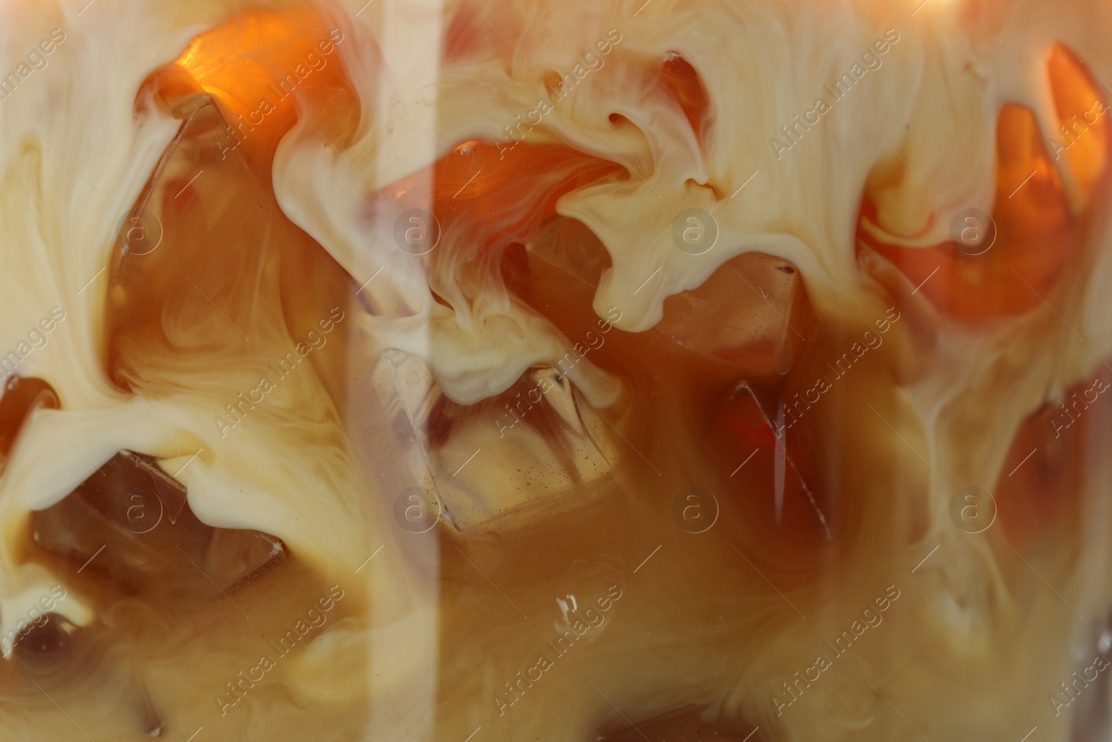 Photo of Refreshing coffee with ice and milk as background, closeup