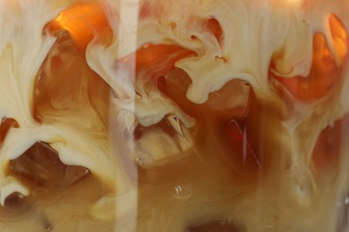 Photo of Refreshing coffee with ice and milk as background, closeup