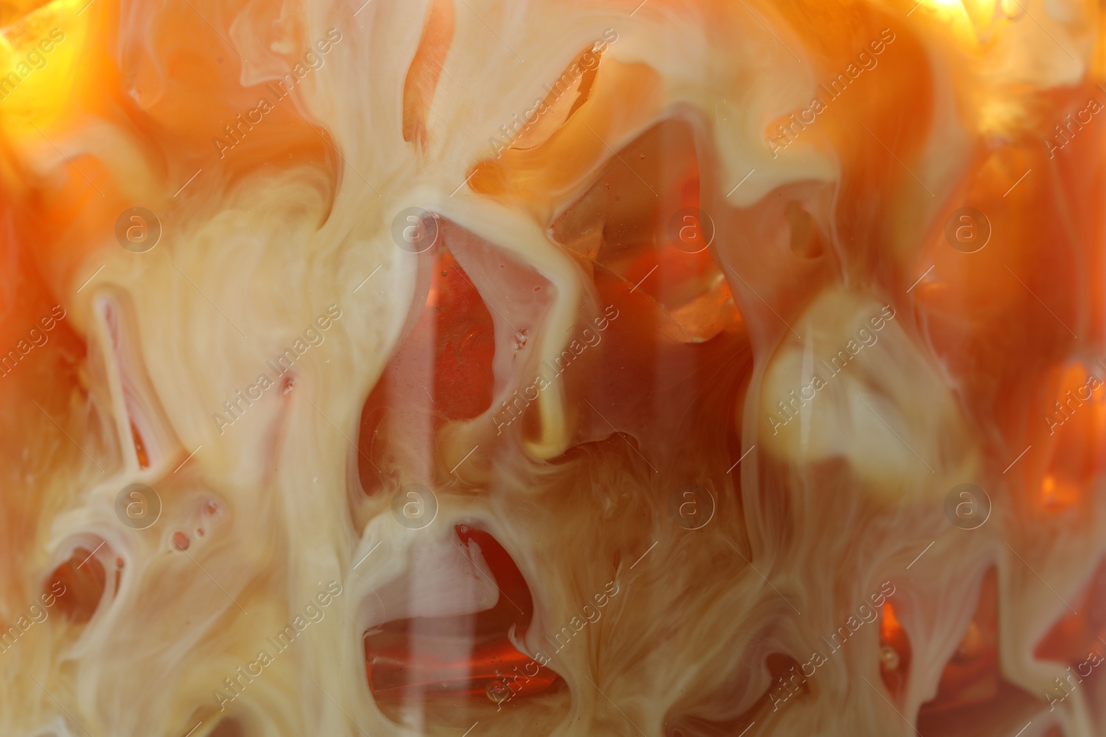 Photo of Refreshing coffee with ice and milk as background, closeup