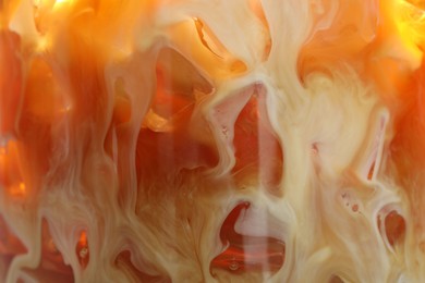 Photo of Refreshing coffee with ice and milk as background, closeup