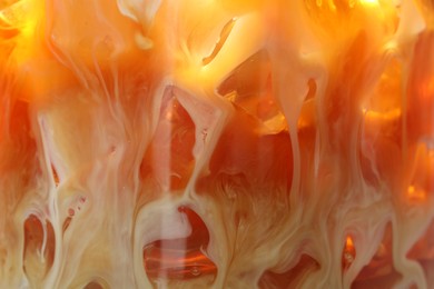 Photo of Refreshing coffee with ice and milk as background, closeup