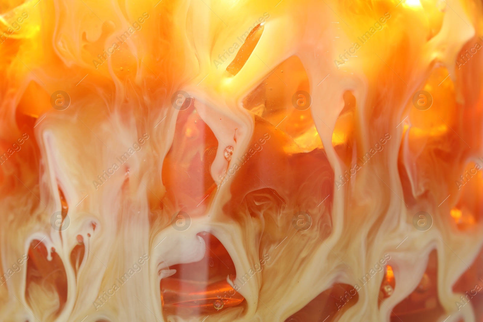 Photo of Refreshing coffee with ice and milk as background, closeup