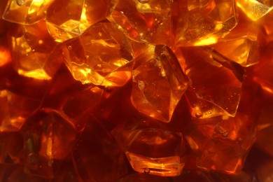 Photo of Refreshing coffee with ice cubes as background, closeup