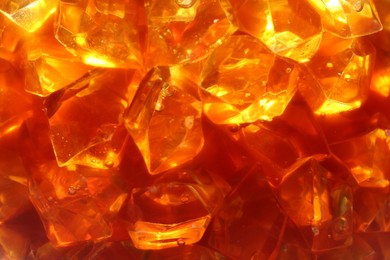 Photo of Refreshing coffee with ice cubes as background, closeup