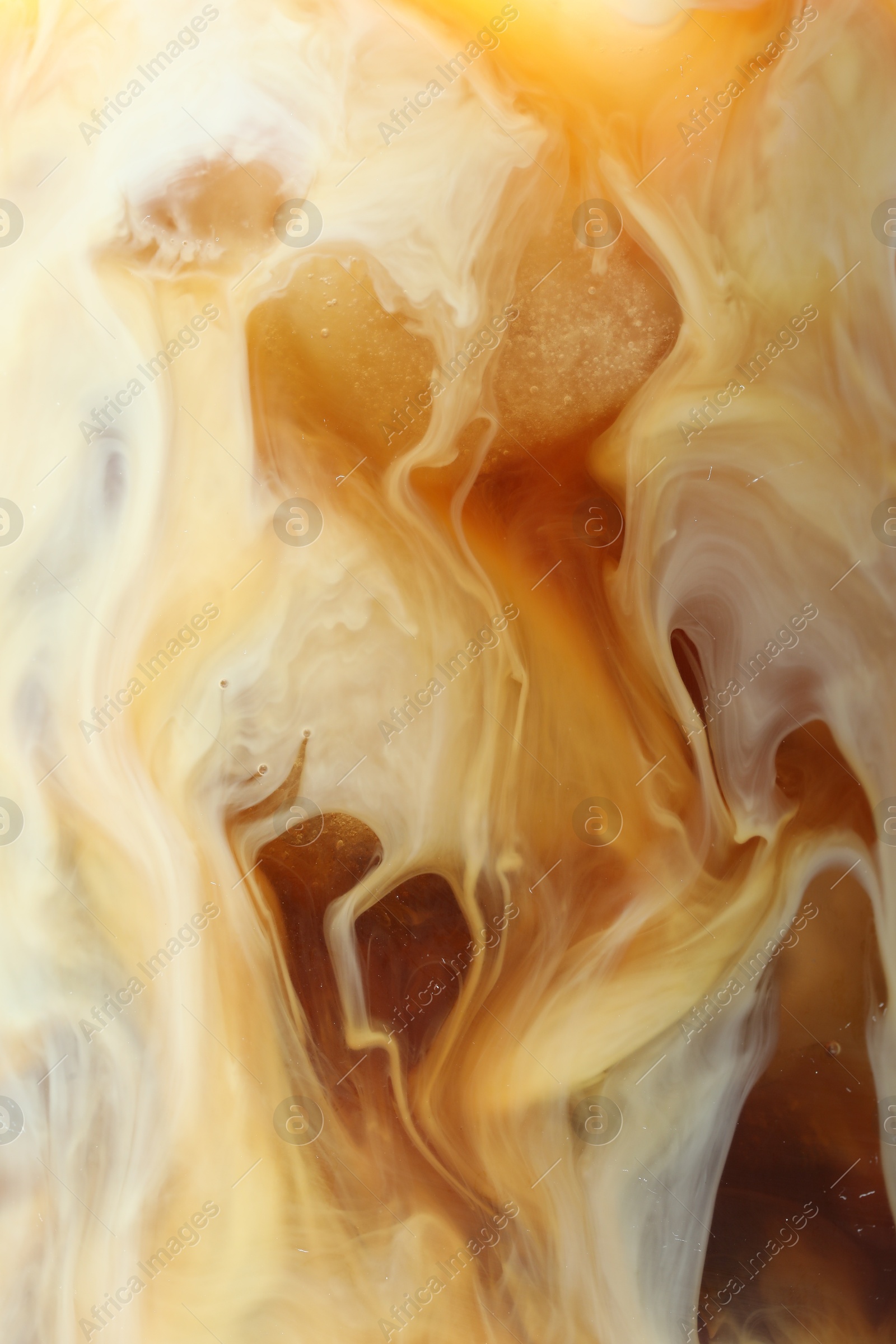 Photo of Refreshing coffee with ice and milk as background, closeup