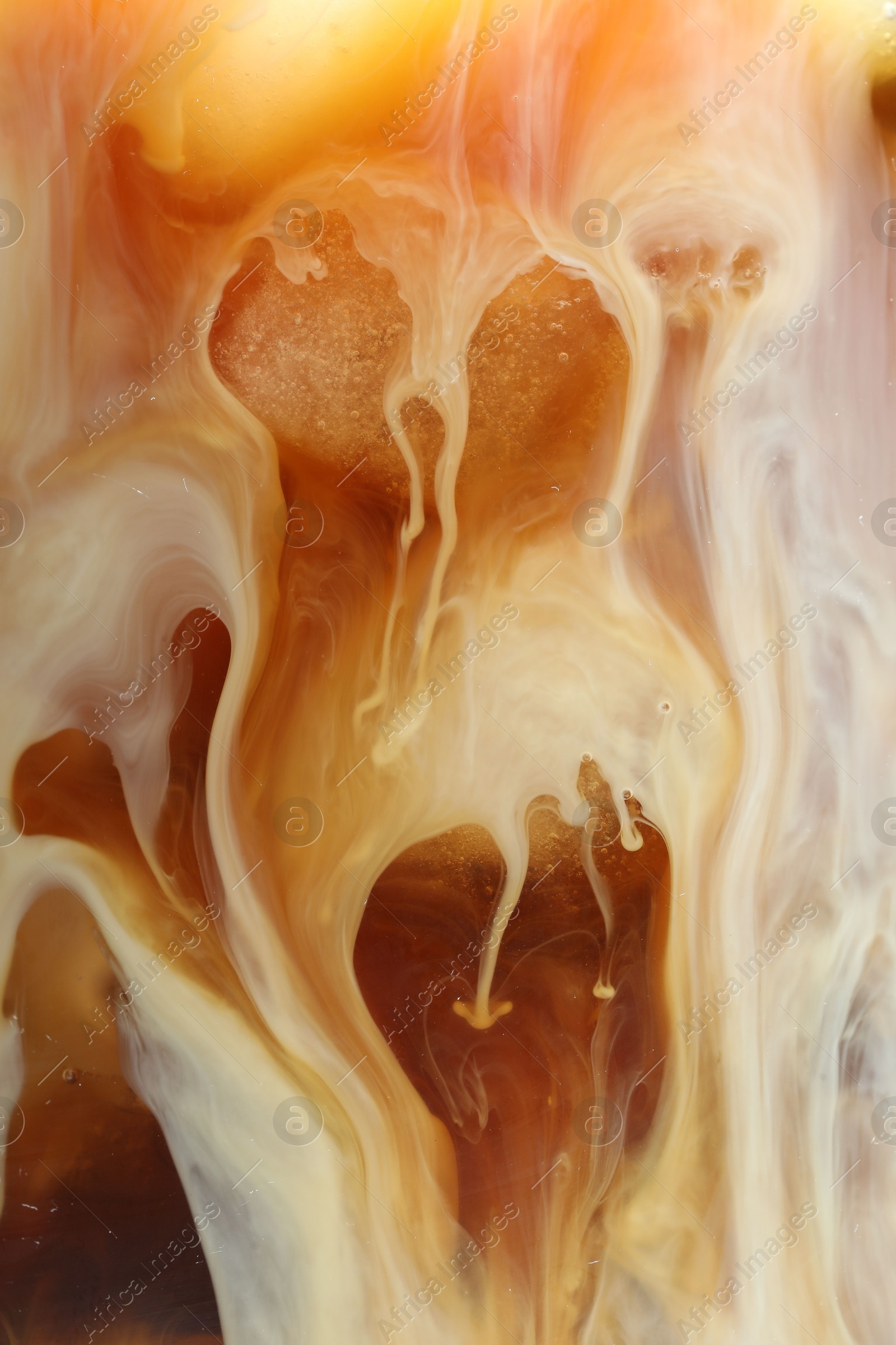 Photo of Refreshing coffee with ice and milk as background, closeup