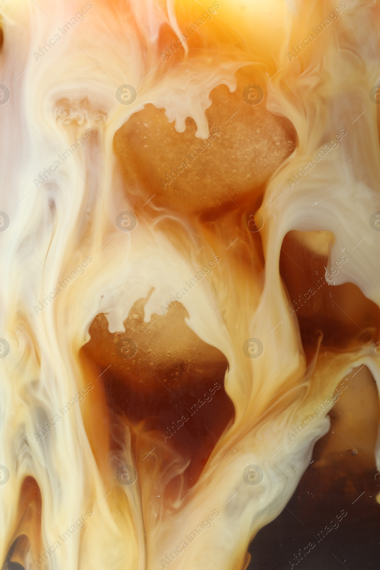 Photo of Refreshing coffee with ice and milk as background, closeup