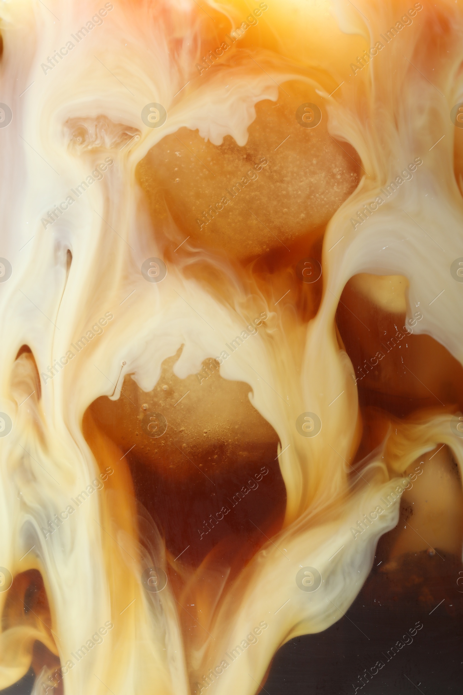 Photo of Refreshing coffee with ice and milk as background, closeup